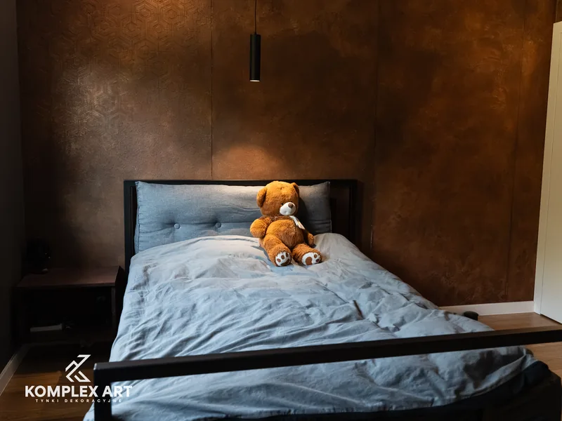 Sypialnia z rdzawą ścianą za łóżkiem, wzór nałożony szablonem, realizacja Komplex Art